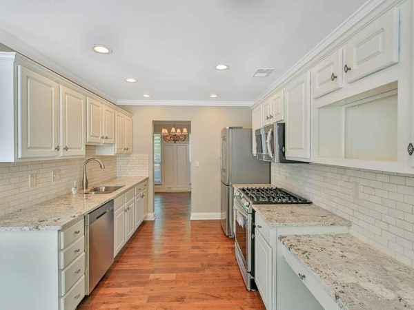 Light Granite Countertops in a White Galley Kitchen
