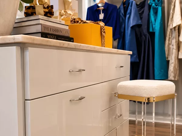High-gloss custom closet dresser with marble countertop and vanity seating by TopSouth Countertops and Closets in Atlanta, GA