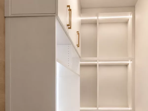 Modern custom closet system with LED-lit open shelving and brass hardware by TopSouth Countertops and Closets in Atlanta, GA