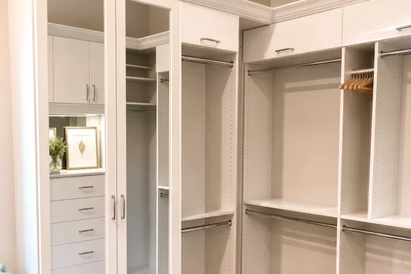 Custom reach-in closet organizer with mirrored doors and adjustable shelving by TopSouth Countertops and Closets in Marietta, GA